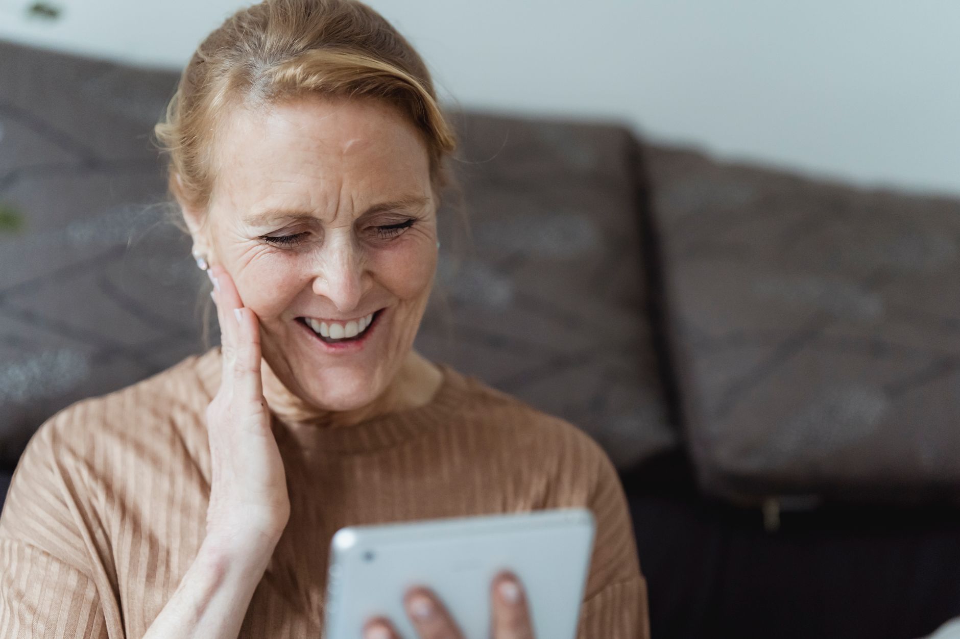 Older woman using a tablet app, illustrating app design older users UK accessibility