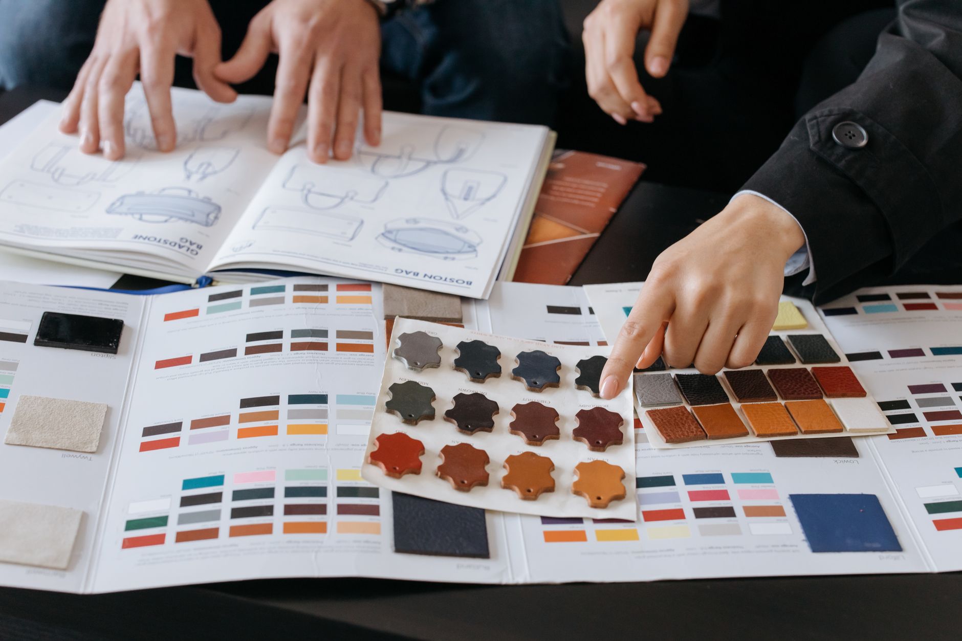 Designer reviewing design system colour tokens UK documentation on a large monitor